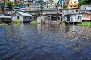 Holzhäuser im Hochwasser des Rio Negro an einem sonnigen Sommertag. Manaus, Amazonas, Brasilien. Konzept der Umwelt, Ökologie, Klimawandel, globale Erwärmung, Naturkatastrophen, Natur.